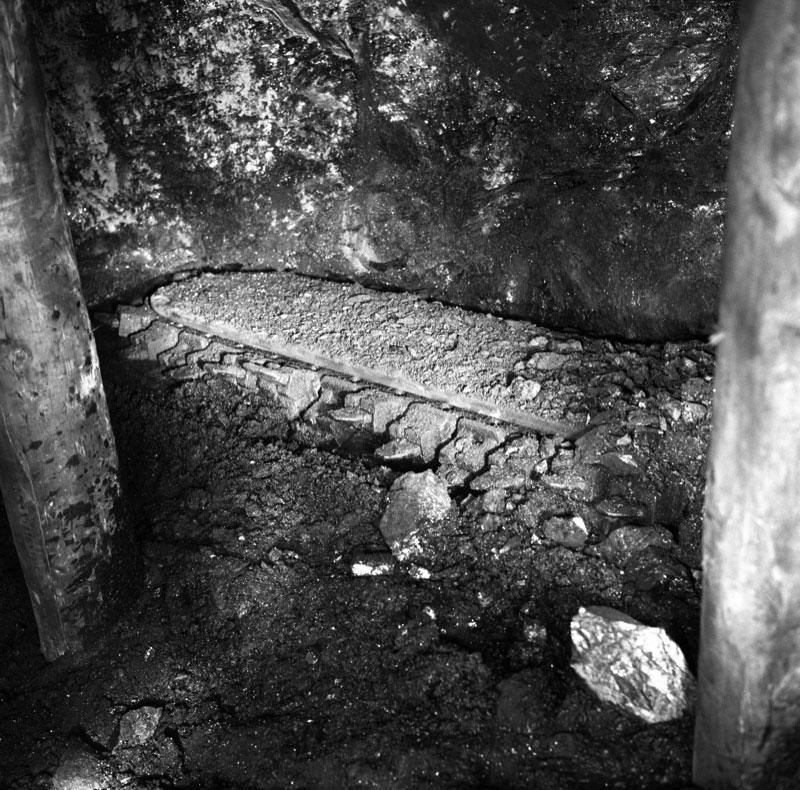 Fernhill Colliery, the jib of an AB 15 hydraulic undercutter on a timbered longwall face
