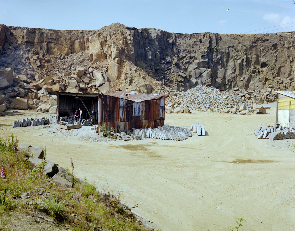 1985 - Beltmoss Quarry, Kilsyth, Strathclyde. Fashioning kerbs from quartz-dolerite., submitted by Buddle-Bot on 08-11-2025.
Bgs No. P001583; © Unknown. Image & Text: BGS Geoscenic, under OGL V2 License http://bit.ly/462AXmV 1985 - Beltmoss Quarry, Kilsyth, Strathclyde. Fashioning kerbs from quartz-dolerite.