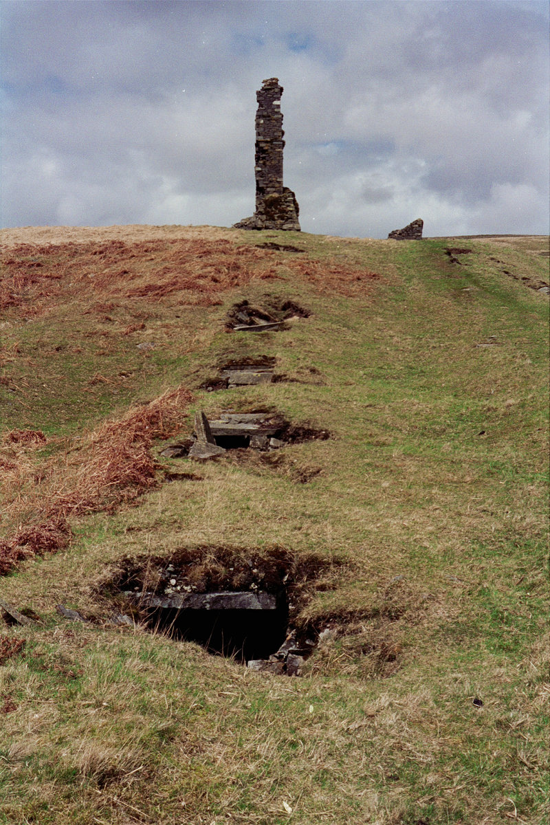 1995 - Ruins of smelter chimneys and slab-roofed trench of flues, Woodhead lead Mine, Carsphairn, south-west Scotland.